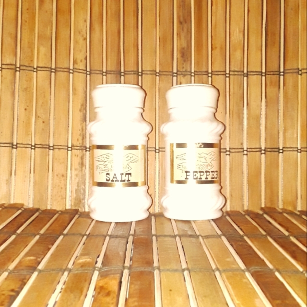 Vintage white milk glass salt & pepper shakers with screw top lids and labels.